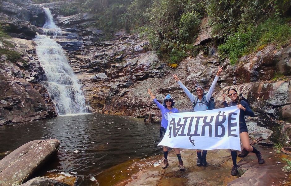 Woman standing on a rock looking at the vast Vale do Pati